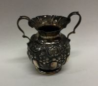 A heavy Edwardian silver two handled vase embossed