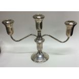 A silver candelabra with scroll decoration. Marked