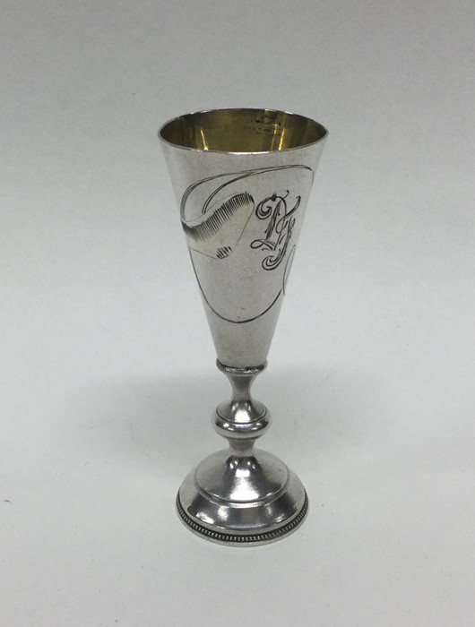 RUSSIAN: A tapering silver vodka tot with engraved