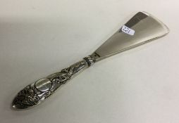 A good Chinese silver shoe horn mounted with a dra