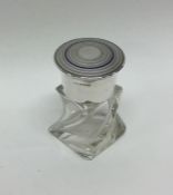 An engine turned silver and enamelled scent bottle