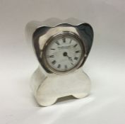 A stylish silver mantle clock of shaped form with