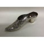 A large silver pin cushion in the form of a shoe w