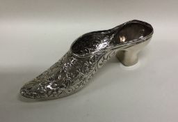 A large silver pin cushion in the form of a shoe w