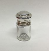 A small cylindrical silver scent bottle with lift-