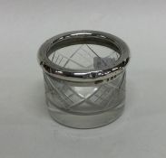 A small circular silver and cut glass salt. London