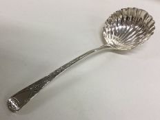 A George III silver sauce ladle with fluted bowl.