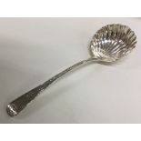 A George III silver sauce ladle with fluted bowl.