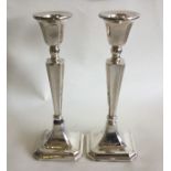 A pair of Edwardian silver candlesticks of taperin