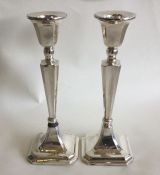 A pair of Edwardian silver candlesticks of taperin