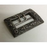 A heavy cast silver buckle of Eastern design decor