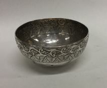 An Antique Burmese silver bowl with scroll decorat