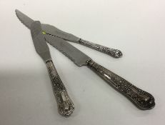 Two silver mounted butter knives together with a c