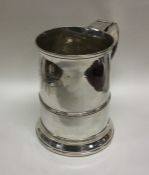 A large Georgian silver tapering quart mug on swee