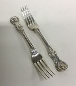 A heavy pair of Kings pattern silver dessert forks