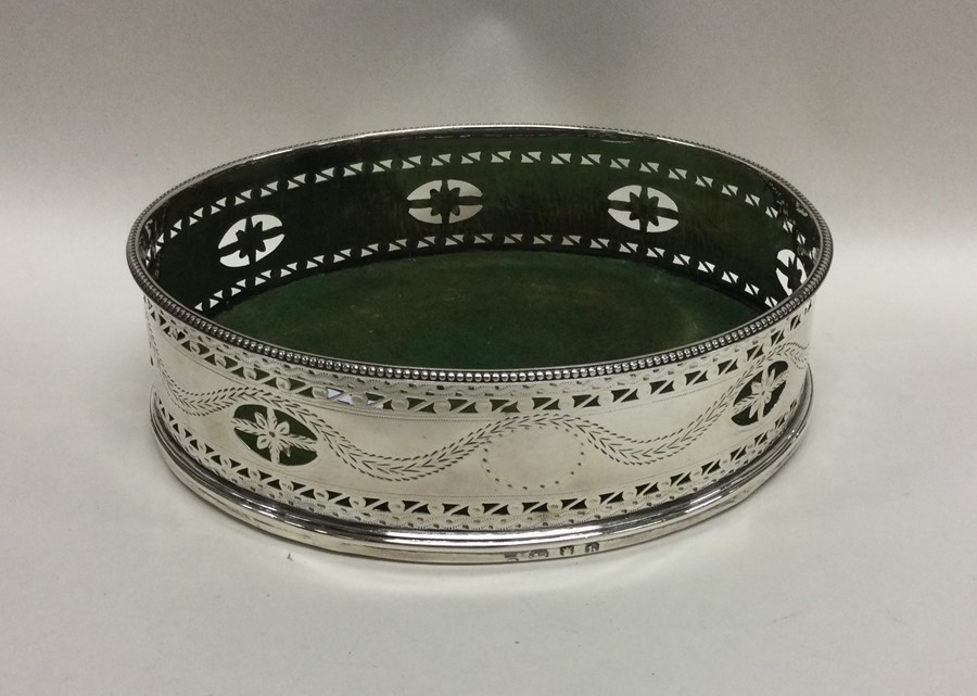 A large oval Georgian pierced silver coaster decora