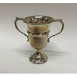 A small Edwardian silver trophy cup of shaped form