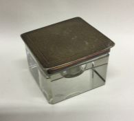 An Edwardian silver inkwell with engine turned top