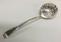 A George III silver sauce ladle with fluted bowl.