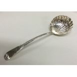 A George III silver sauce ladle with fluted bowl.