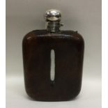 A large silver and leather mounted flask with hing