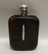 A large silver and leather mounted flask with hing