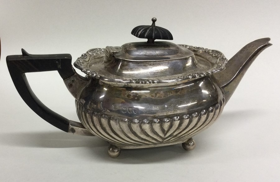 An Edwardian silver bachelor's teapot on ball feet
