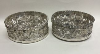A good pair of Georgian silver coasters profusely