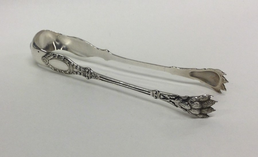 A good heavy pair of Antique silver ice tongs with
