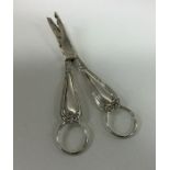 A heavy pair of silver grape scissors decorated wi