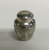 An unusual chased silver pepper of Chinese design.
