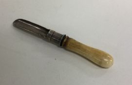 A Georgian silver apple corer with ivory handles.