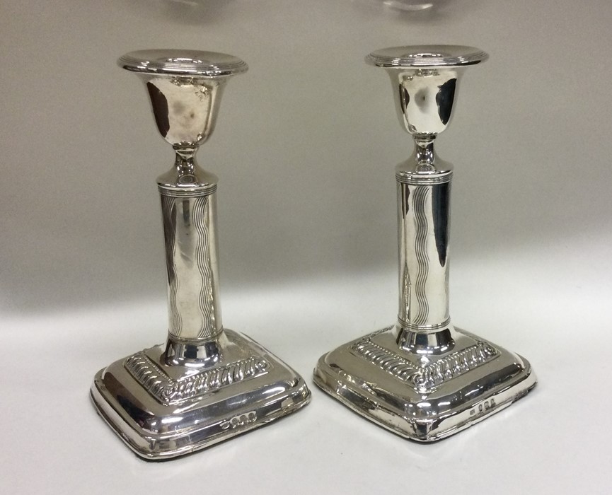 A pair of Edwardian silver candlesticks with reede - Image 2 of 2