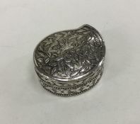 An unusual kidney shaped silver pill box decorated