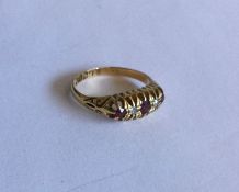 A ruby and diamond five stone ring in gold claw mo