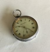 A large silver open faced pocket watch with white