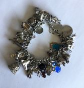 A heavy silver curb link charm bracelet with heart