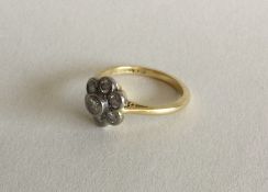 A heavy circular daisy head cluster ring set in 18