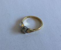 An 18 carat gold and diamond single stone ring. Ap