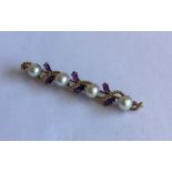 A heavy 14 carat amethyst and pearl brooch. Approx