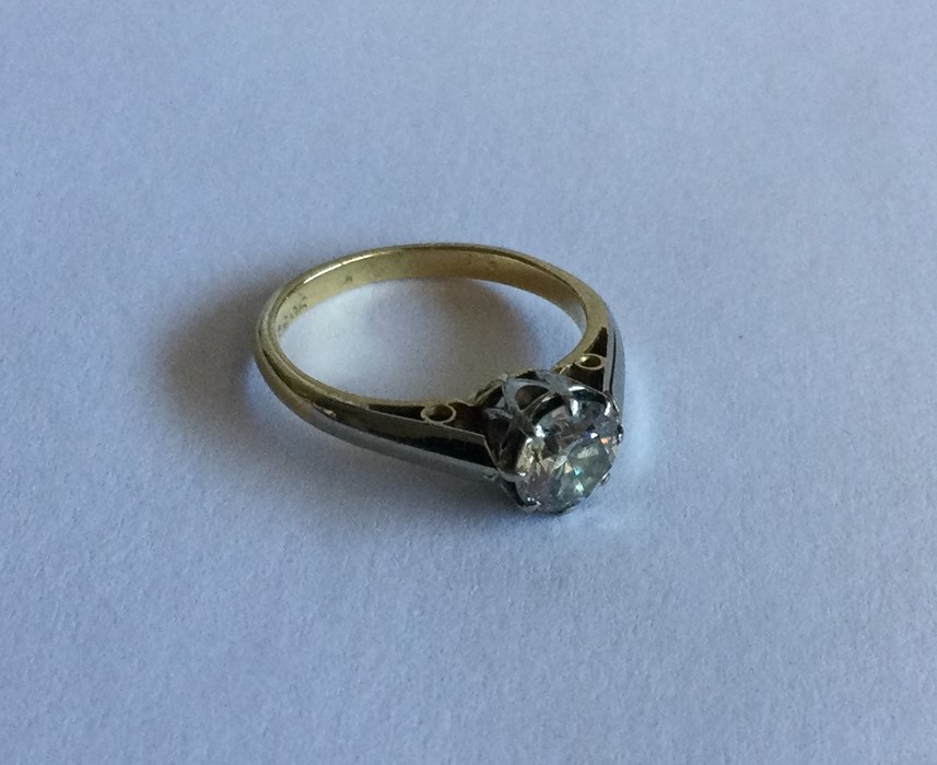 A diamond single stone ring in two colour 18 carat