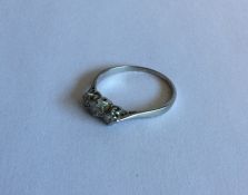 A platinum mounted three stone diamond ring. Appro