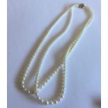 A double string of pearl beads with 9 carat gold c