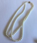 A double string of pearl beads with 9 carat gold c