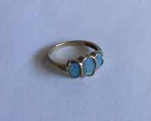 An opal three stone ring in 9 carat mount. Approx.