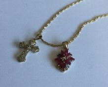 A 9 carat ruby and diamond pendant on fine link ch