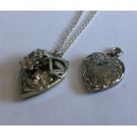 A silver locket on fine link chain together with o