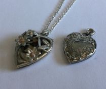 A silver locket on fine link chain together with o