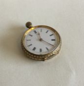 A gold fob watch with white enamelled dial. Approx