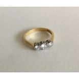 A good diamond three stone ring in two colour gold